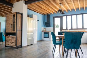 a kitchen and dining room with a table and chairs at Campagne et Mer in Perpignan