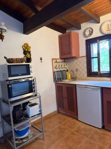 a kitchen with a tv and a counter top at Finca Nim 1 in Mogán +15 photos