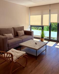 a living room with a couch and a coffee table at Canto de la Perdiz in Villafranca del Bierzo