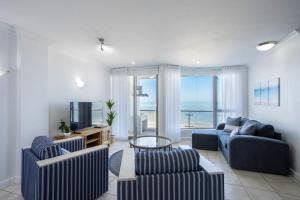 a living room with two couches and a television at Hibernian Towers 408 in Strand