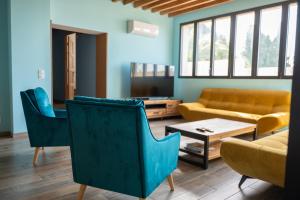 a living room with a couch and chairs and a table at Campagne et Mer in Perpignan