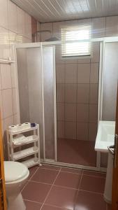 a bathroom with a shower and a toilet and a sink at Rosemary Kütle pansiyon in Cıralı +108 photos