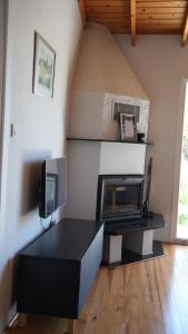 a living room with a black desk with a microwave at Coollyhouse Keklik tepe Urla in Urla