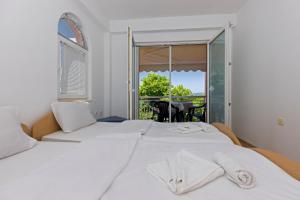 a bedroom with two beds and a balcony at Nikola Apartments in Ohrid