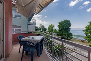 a balcony with a table and chairs and a view of the ocean at Nikola Apartments in Ohrid