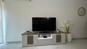 a flat screen tv sitting on top of a white entertainment center at Victoria Palace T2 de 50m2 in Menton