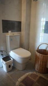 a bathroom with a white toilet and a basket at Coollyhouse Keklik tepe Urla in Urla +91 photos