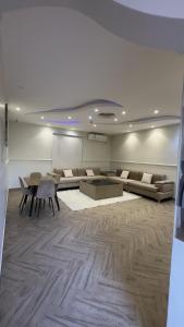 a living room with couches and a table in a room at منتجع وفلل المرفأ ابها in Abha