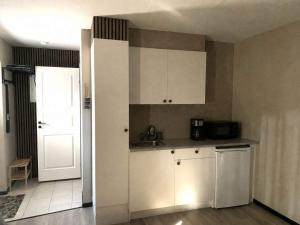 a kitchen with a sink and a refrigerator and a door at 4 star holiday home in SÖLVESBORG in Sölvesborg +21 photos