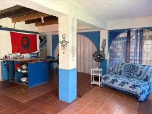 a living room with a table and a couch at Casa Azul by Silvia Sàmara in Nicoya