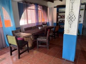 a dining room with a wooden table and chairs at Casa Azul by Silvia Sàmara in Nicoya +20 photos