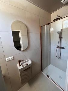 a bathroom with a shower and a sink and a mirror at naMaaStay in Maastricht
