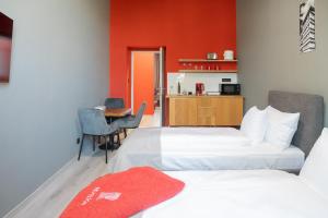 a hotel room with two beds and a kitchen at Revelton Ostrava in Ostrava