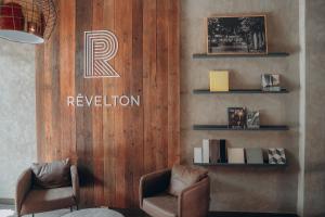 a room with two chairs and a sign on a wall at Revelton Ostrava in Ostrava
