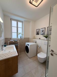 a bathroom with a toilet and a sink and a shower at Herzstück in Ansbach +7 photos