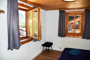a bedroom with a bed and a window with a view at Mountain Lodge Stubai in Neustift im Stubaital +53 photos