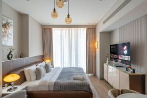 a hotel room with a large bed and a television at Luxurious Studio Marina View Condor Marina Star in Dubai