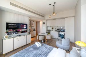 a living room with a bed and a kitchen at Luxurious Studio Marina View Condor Marina Star in Dubai