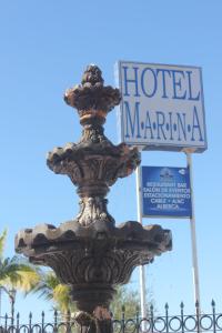 a fountain in front of a hotel marmite sign at Hotel Marina Topolobampo in Topolobampo