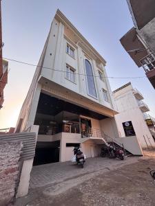 a building with two motorcycles parked in front of it at Raghuwar Palace in Ayodhya