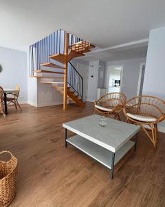 a living room with a table and chairs and a staircase at Canto de la Perdiz in Villafranca del Bierzo