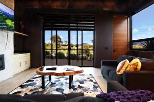 a living room with a couch and a table at Parra del Valle Hotel Boutique in Valle de Guadalupe