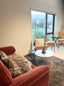 a living room with a couch and a table at Brightside Suite in Kristiansand