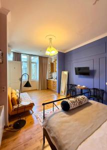 a bedroom with a large bed and a living room at Arts Hotel Tbilisi in Tbilisi City
