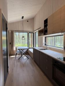 a kitchen with a sink and a table in it at Femund Canoe Camp in Drevsjø