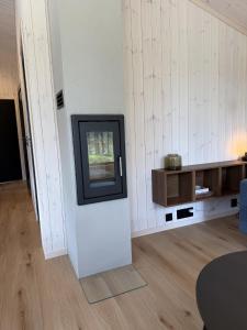 a living room with a tv on a wall at Femund Canoe Camp in Drevsjø