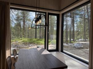 a dining room with a table and a large window at Femund Canoe Camp in Drevsjø