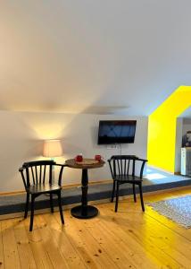 a dining room with two chairs and a table at Arts Hotel Tbilisi in Tbilisi City