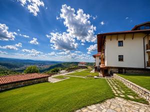 a house on a hill with a green lawn at Sevastokrator Relax & Congress in Arbanasi