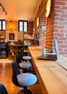 a coffee shop with a laptop on a wooden counter at Arts Hotel Tbilisi in Tbilisi City