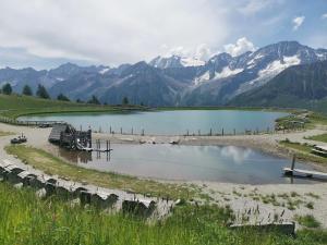 a body of water with mountains in the background at Appartamento Aurora - Passo del Tonale in Passo del Tonale