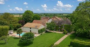 an aerial view of a house with a yard at Les CHARMES in Jugy