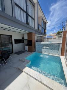 a swimming pool in the backyard of a house at Flat do Lucca 02 - Piscina - 50m da Praia - Até 10 Pessoas in Tamandaré +14 photos