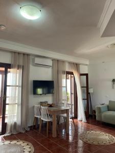 a living room with a table and a couch at Seaside Athos I in Ouranoupoli