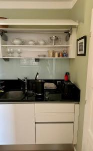 a kitchen with a sink and a counter top at Villa Conte Private Urban Hideaway in Wels +34 photos