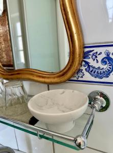 a bathroom with a sink and a mirror at Villa Conte Private Urban Hideaway in Wels