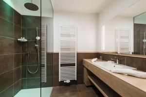 a bathroom with a shower and a sink at Hotel Greifenstein in Terlano