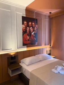 a bedroom with a poster of a group of people at Villa Theodora Boutique Stay in Fanari +41 photos