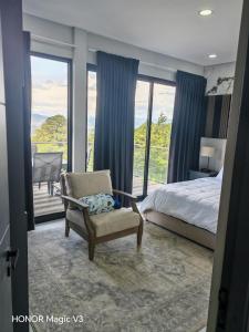 a bedroom with a bed and a chair and a balcony at La Parada House 25 in Concepción +47 photos