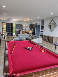 a pool table in the middle of a living room at La Parada House 25 in Concepción