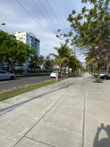 an empty street with palm trees on the side of the road at Moderno Apartment Near the Ocean Santo Domingo Este Wife ,AC in La Francia