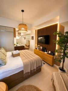 a bedroom with a large bed and a kitchen at Sky26 Stays by Paula & Hudson in Pampang +30 photos
