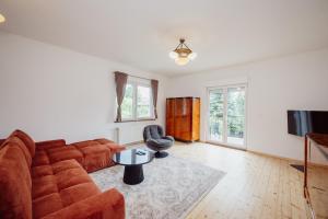 a living room with a couch and a tv at Willa Berg Cieplice in Jelenia Góra