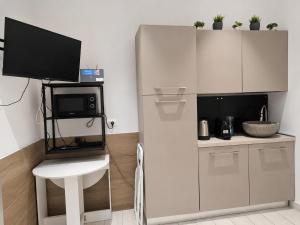 a small kitchen with a microwave and a counter with a table at Monolocale Incantevole in Montichiari