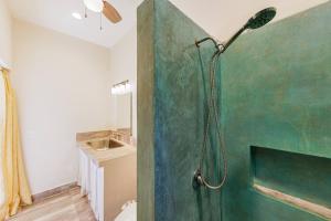 a shower in a bathroom with a green wall at Ocean View Studio Near Los Barriles in Buenavista