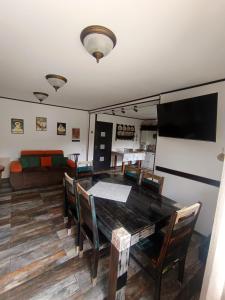 a dining room with a table and chairs and a couch at CASA de VIS in Sinaia